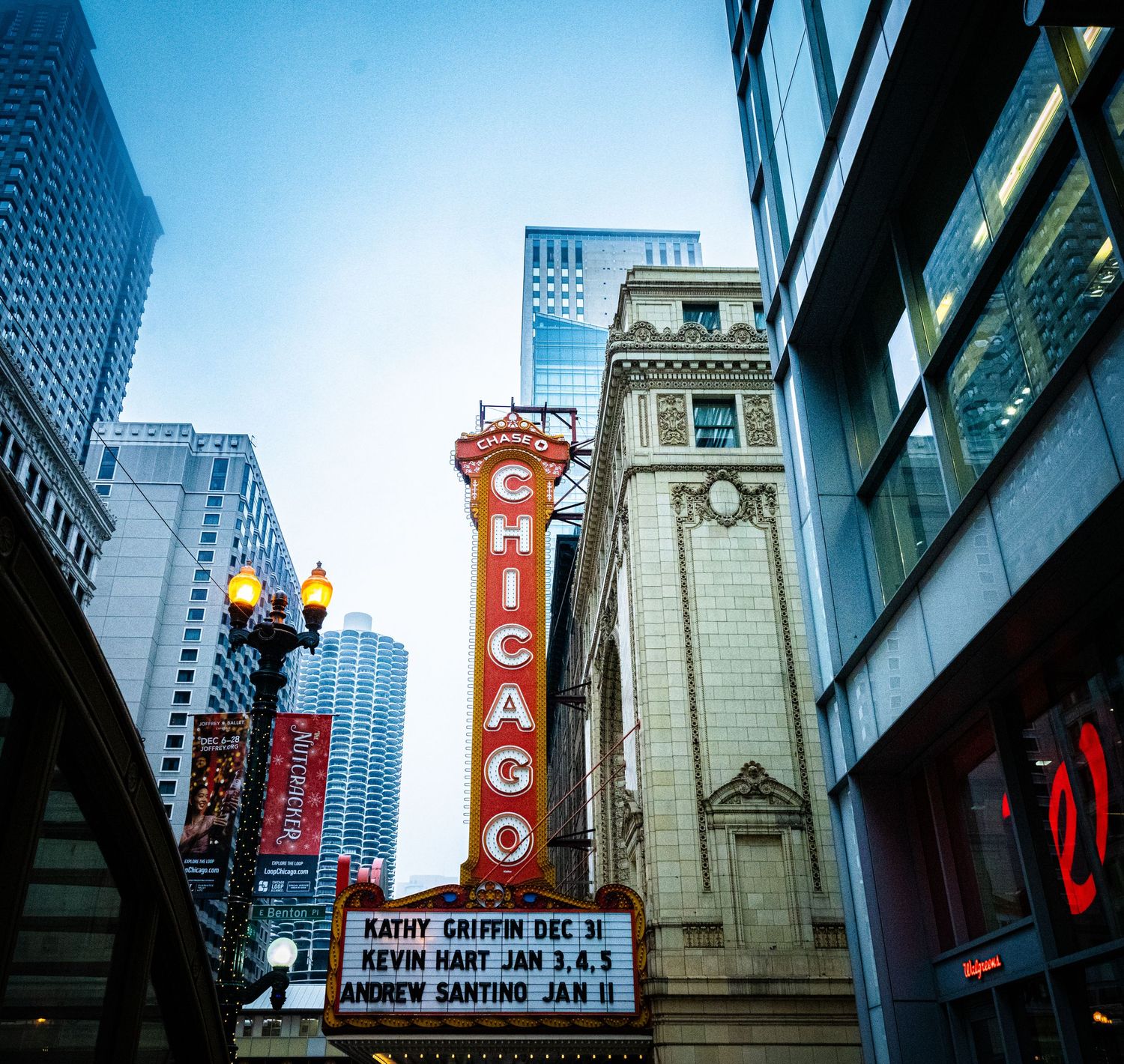 Urban street view with vintage theater marquees and tall buildings in downtown Chicago.