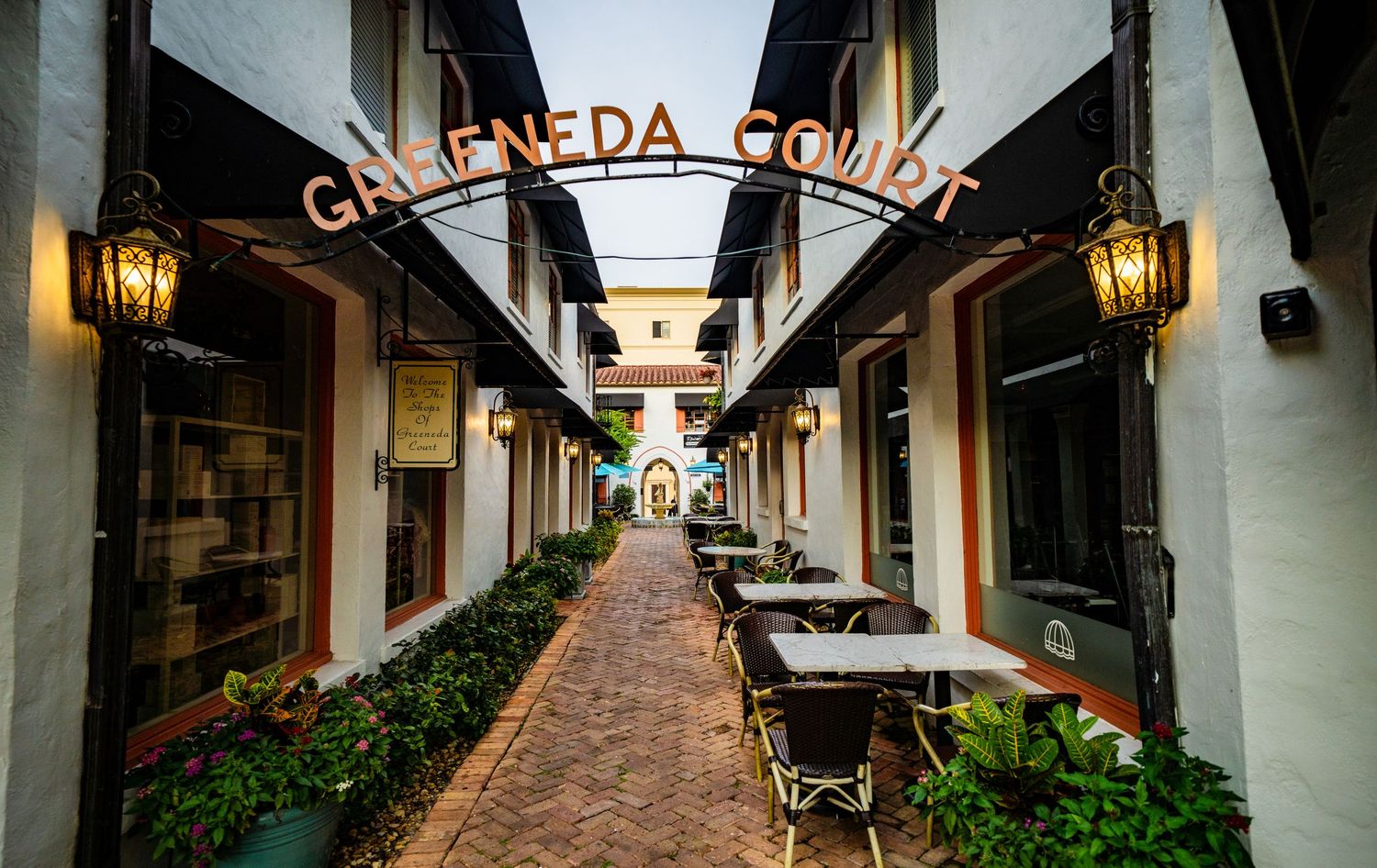 Covered shopping arcade with lanterns and Granada Court signage spanning the walkway.