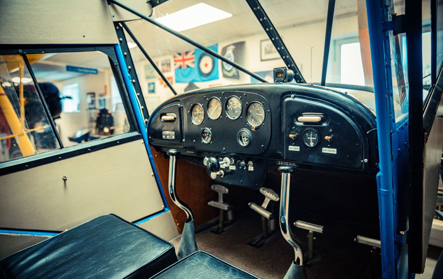 Vintage aircraft instrument panel showing gauges and controls in cockpit display.