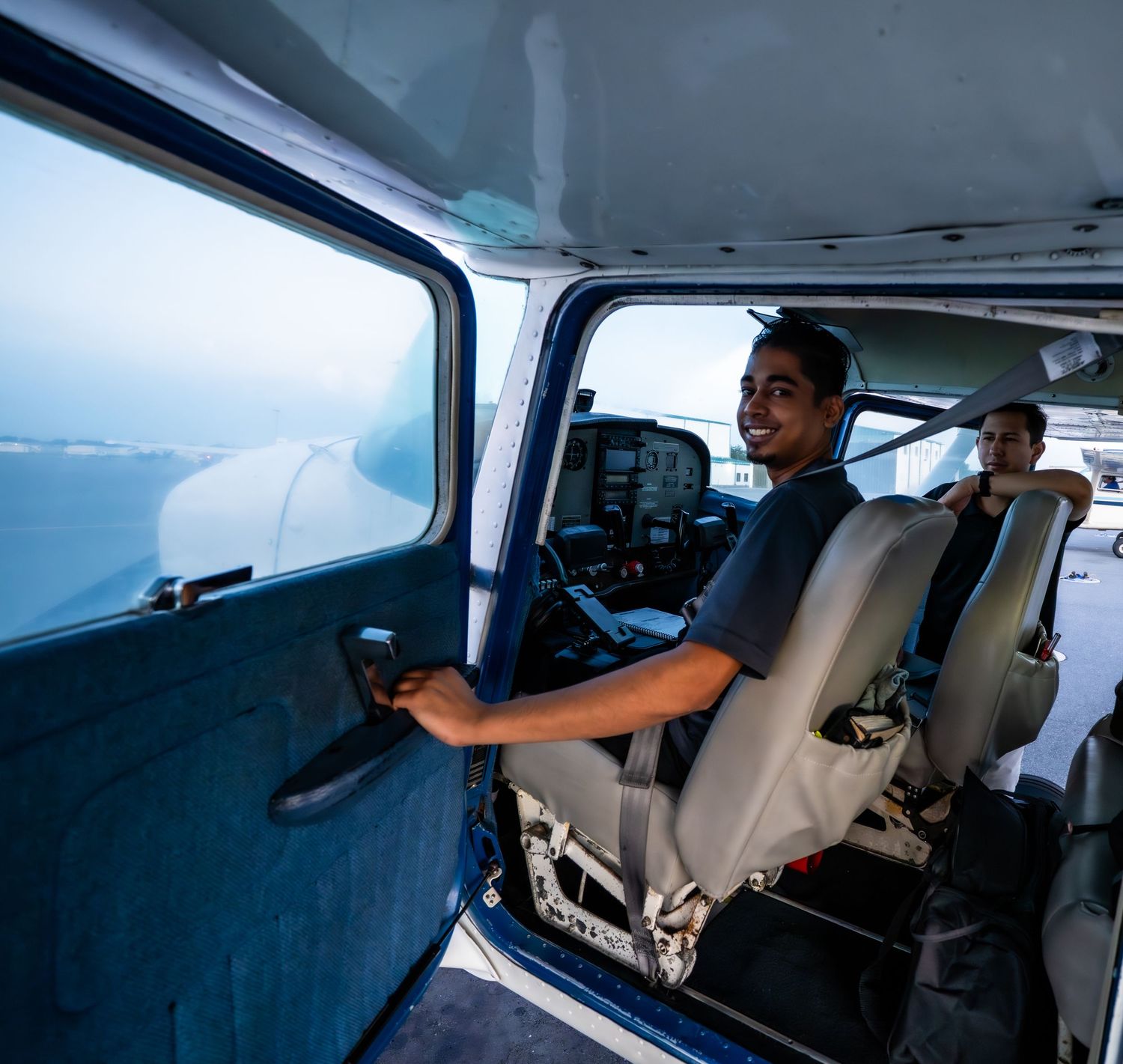 Interior view of small aircraft cockpit showing control panels and instruments.