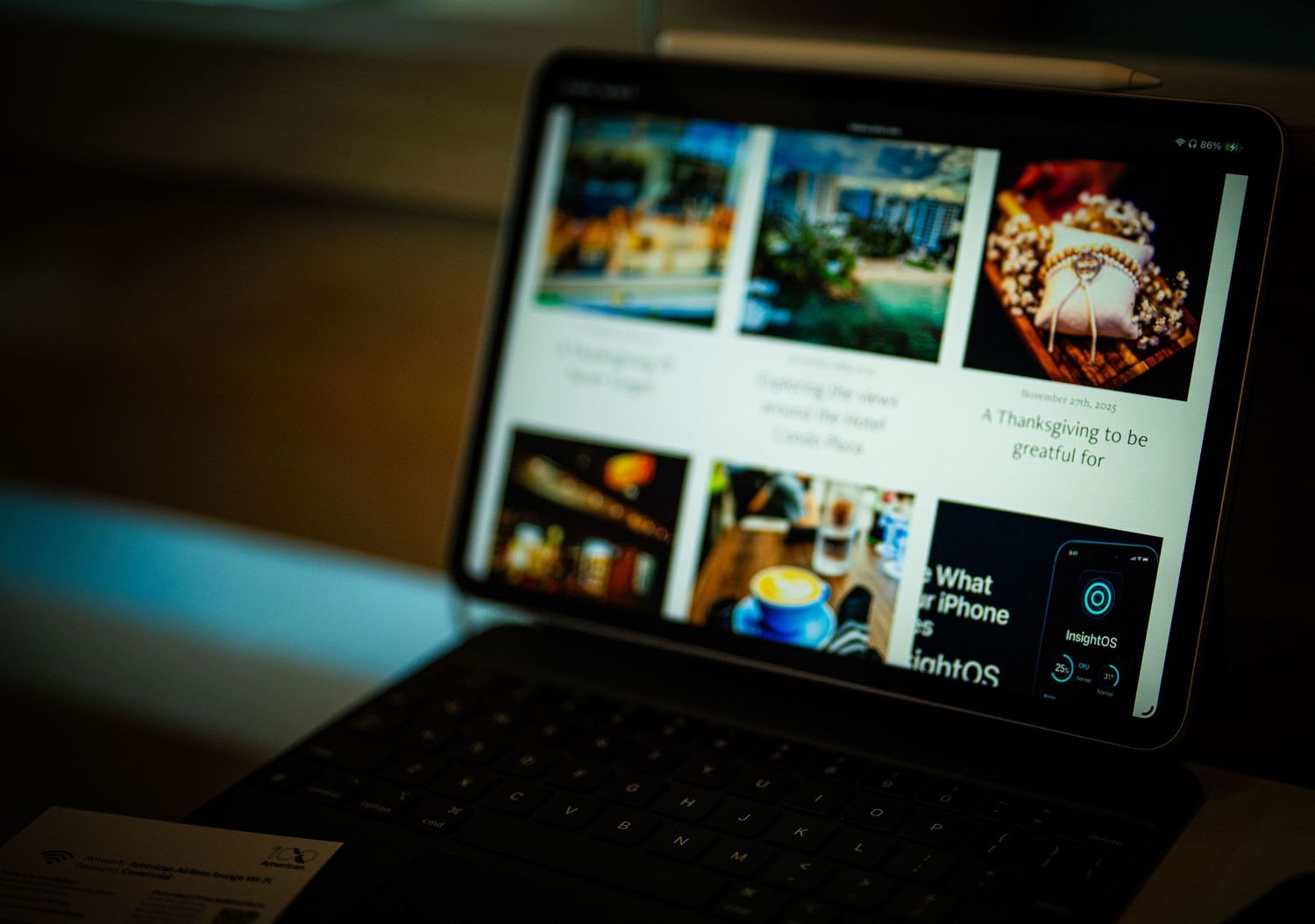 A dark and moody photo of a laptop keyboard with blurred background lighting creating an atmospheric scene.
