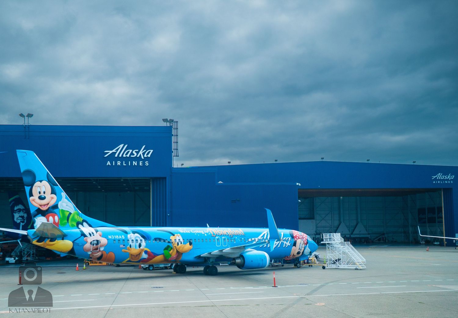 Alaska Airlines hangar and maintenance facility with Disney character artwork visible.