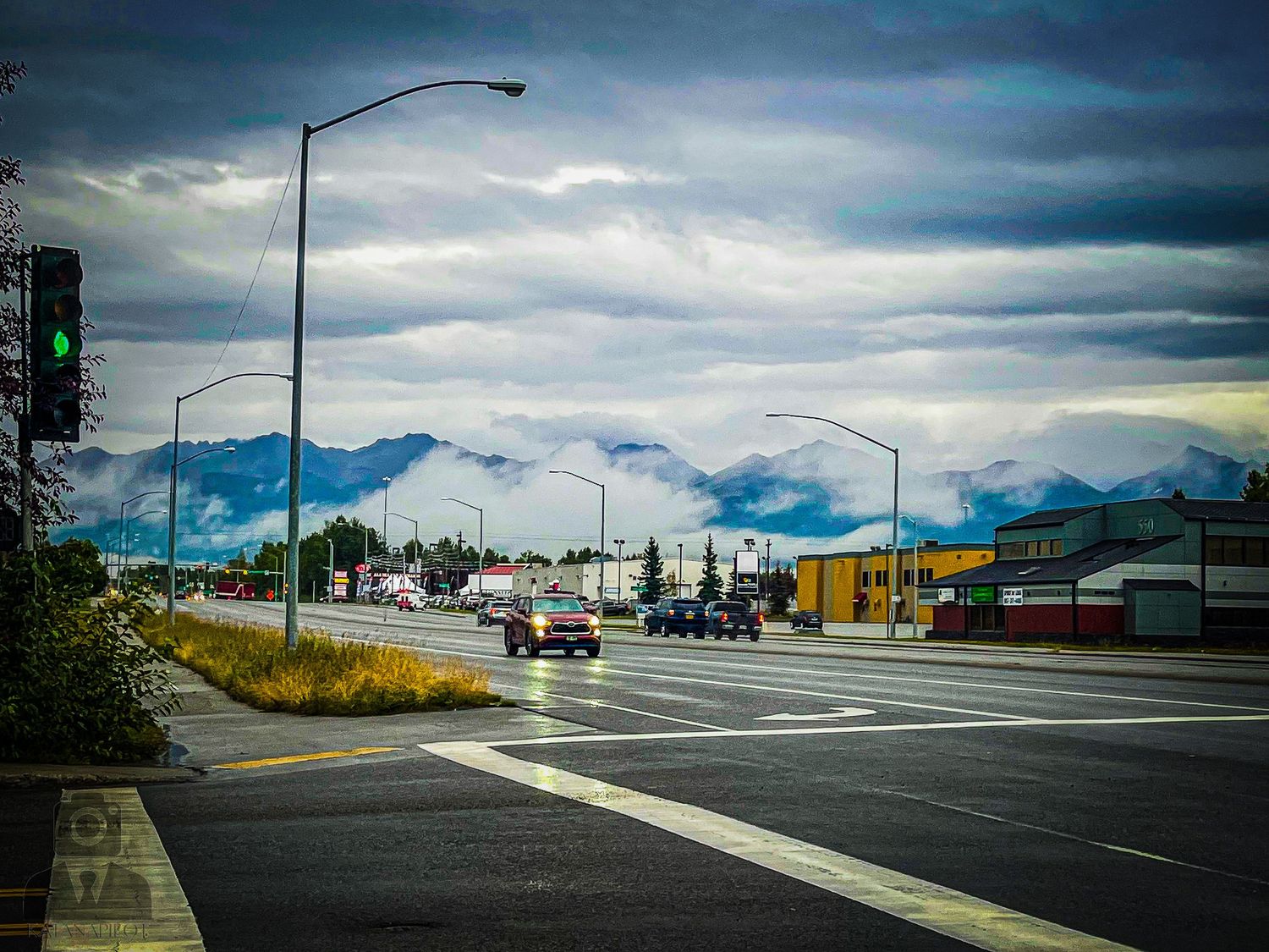 Panoramic view of empty streets and buildings with mountains in background.