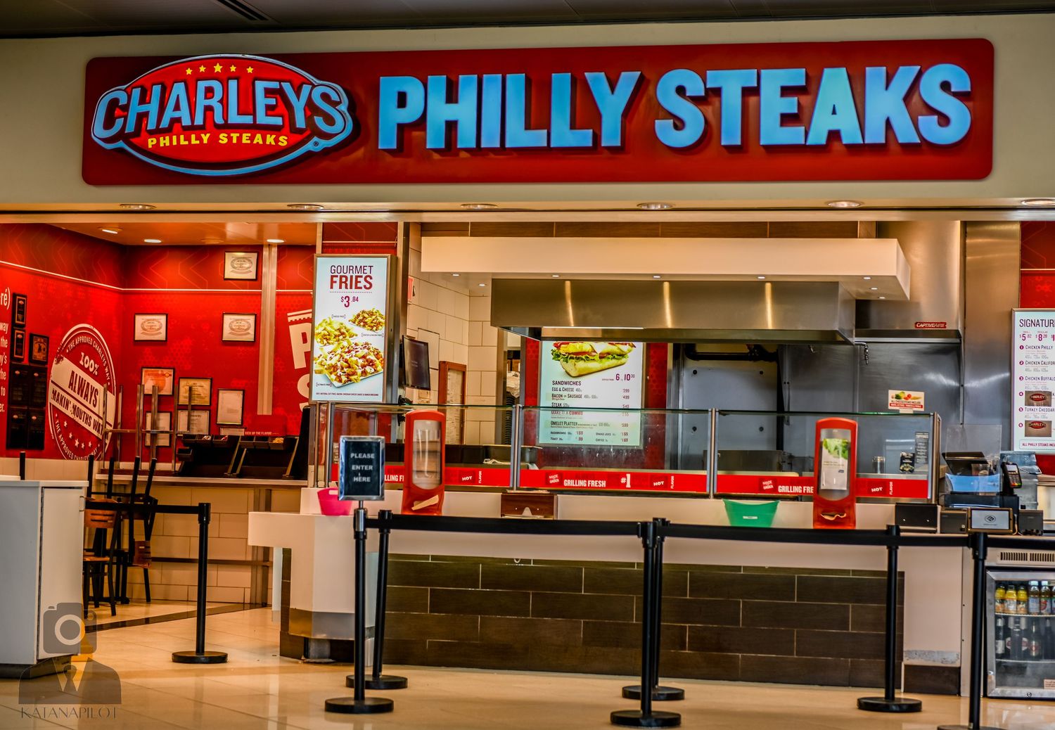 Charley's Philly Steaks restaurant counter with red signage and ordering queue area.