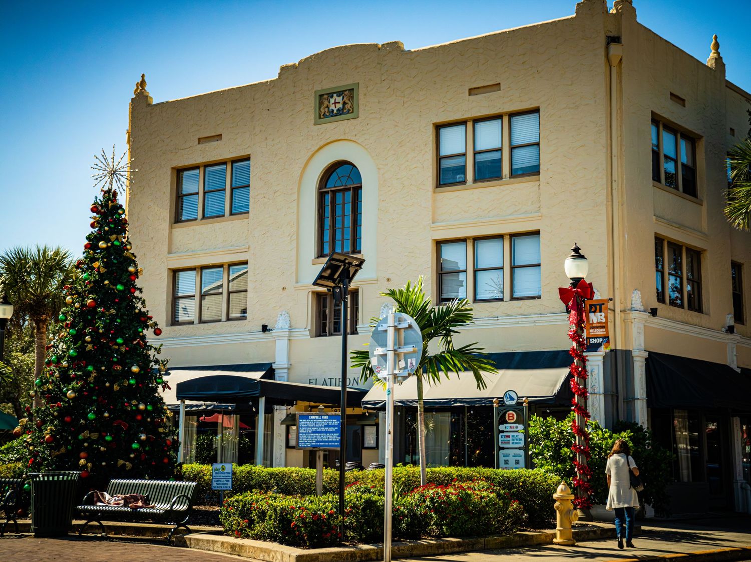 Exterior views of a beige art deco style building with multiple windows and landscaping shown from different angles.