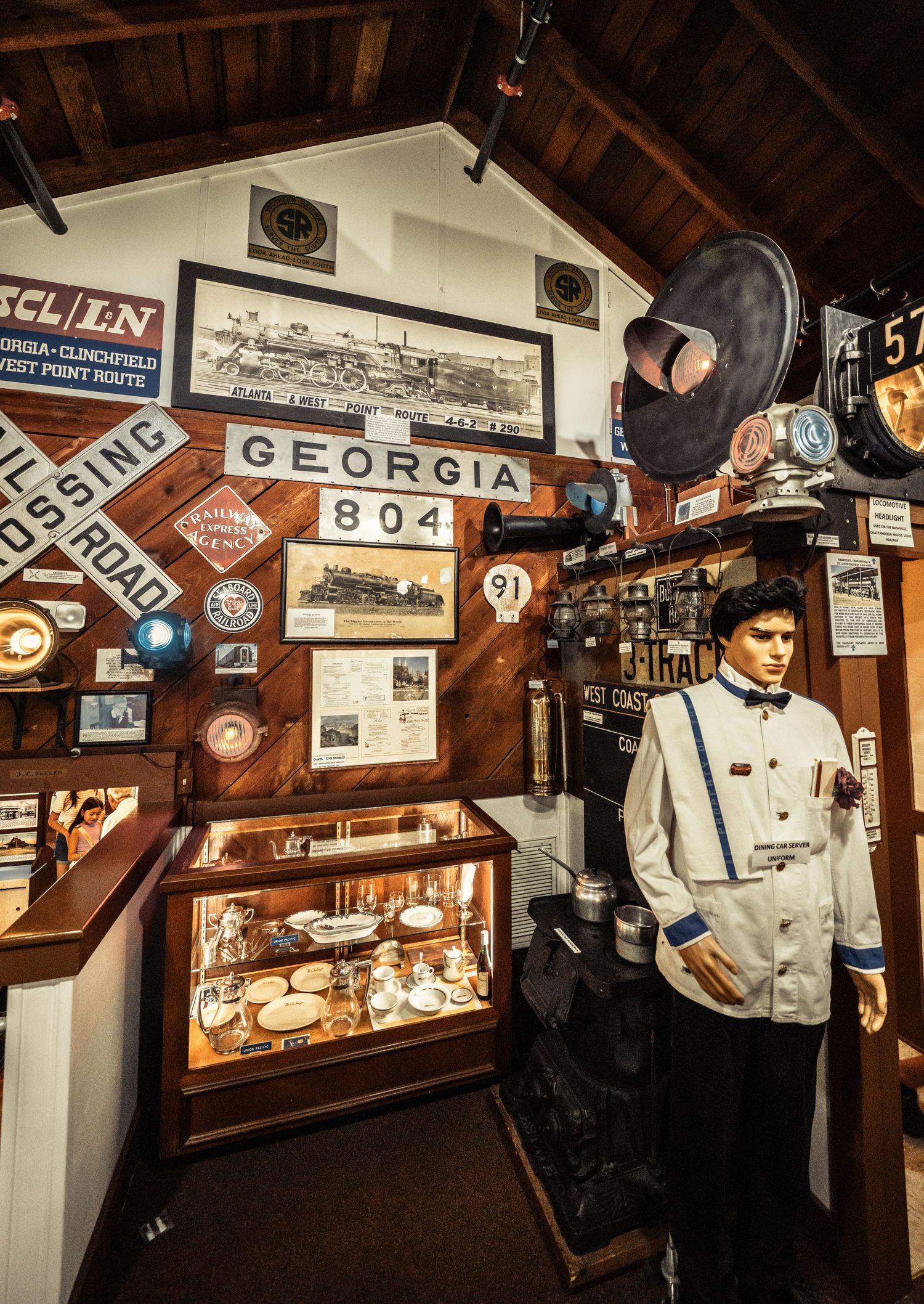 Historic railroad museum interior with vintage signage and display cases showing transportation artifacts.