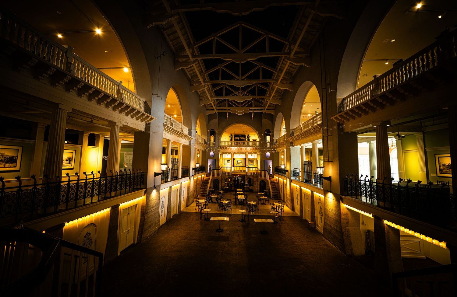 Dark atmospheric corridor with arched ceilings and dramatic lighting in historic building.