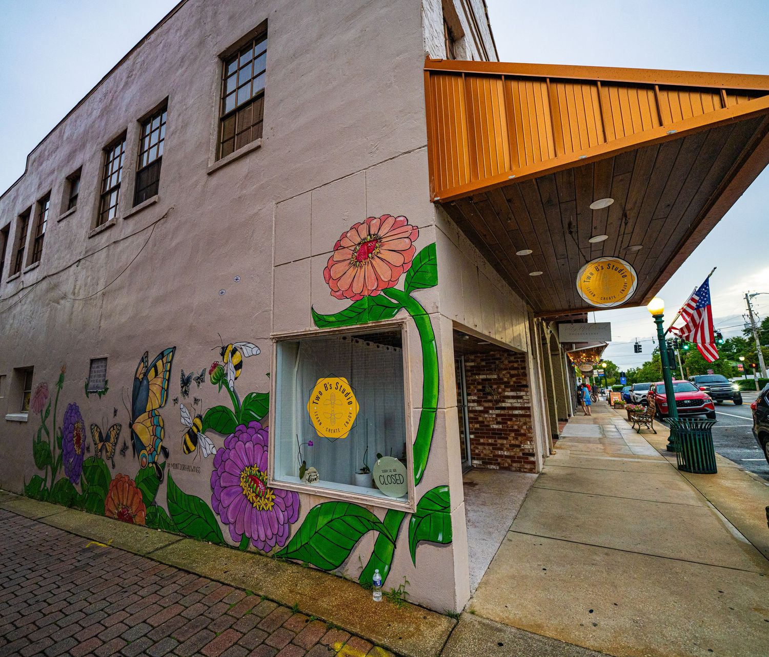 Building wall decorated with colorful floral and nature-themed murals.