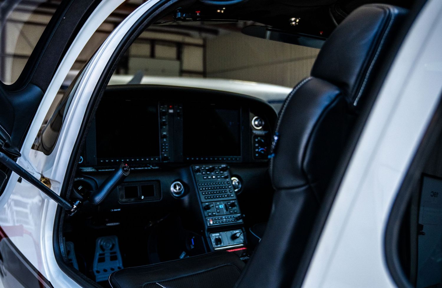 Interior view of aircraft cockpit showing modern digital instrumentation.