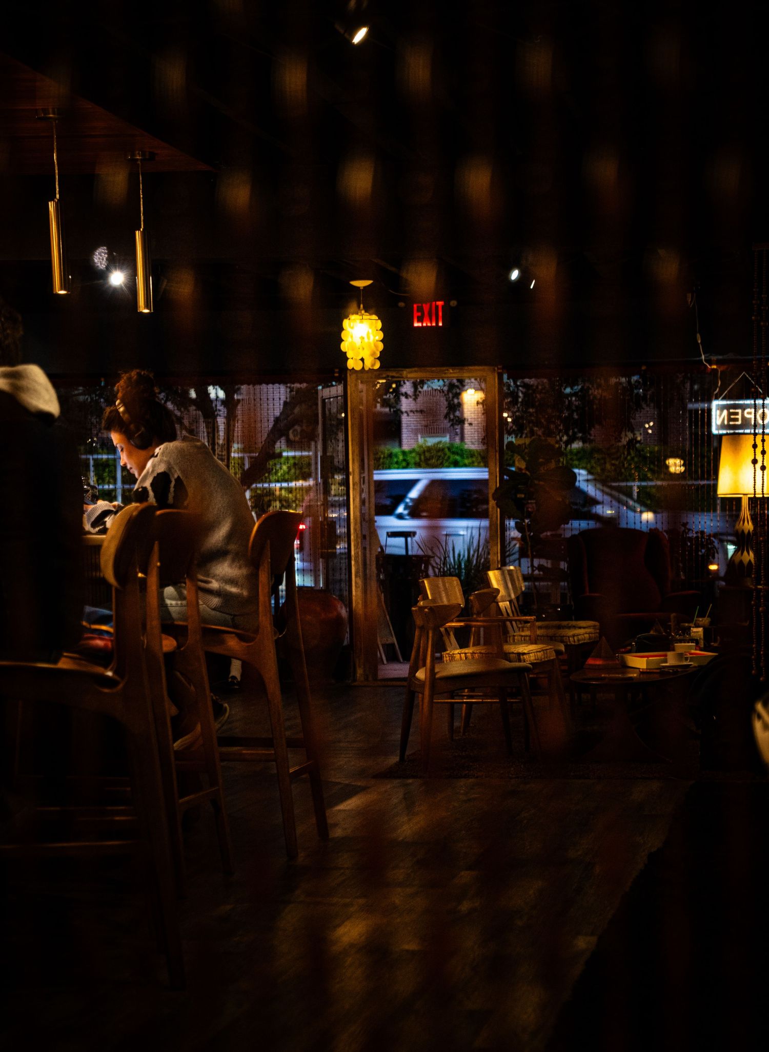 Dark bar scene with silhouettes and ambient lighting creating a moody nightlife atmosphere.