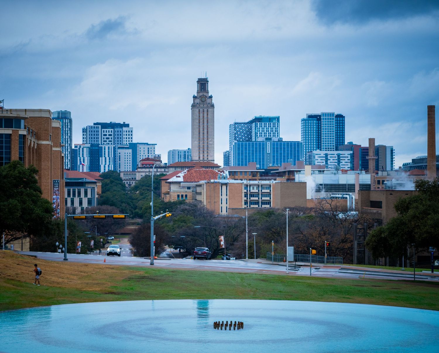 Panoramic view of Austin skyline with Capitol building visible in the distance on a cloudy day.