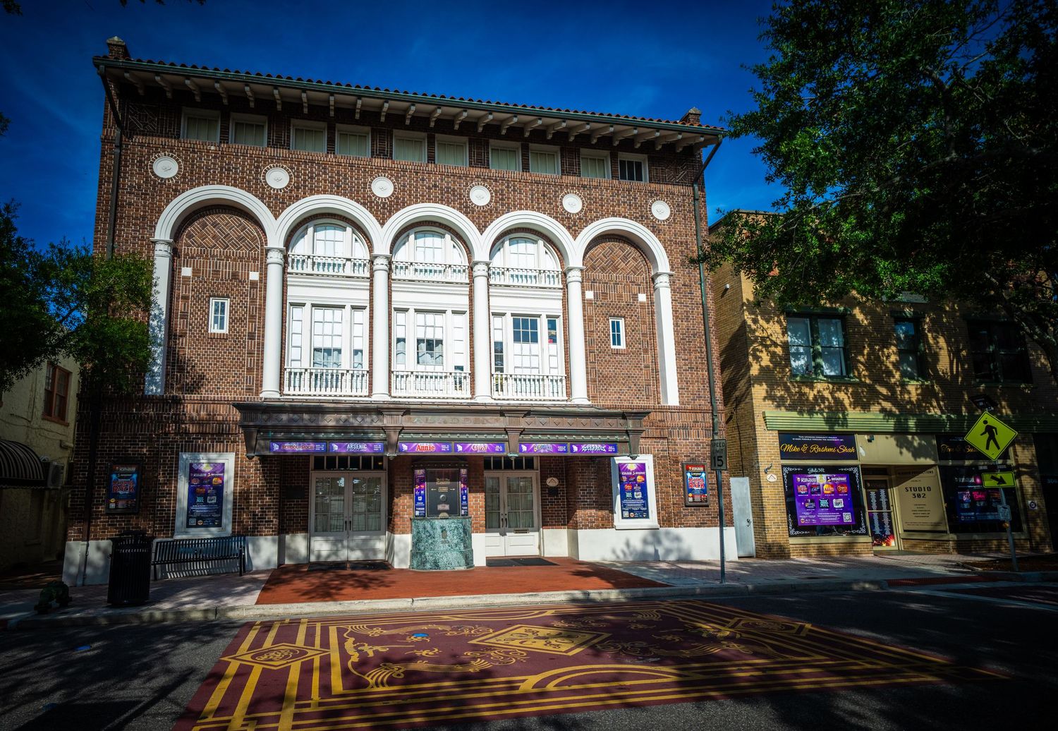 Historic brick theater building with arched windows and classic architectural design.