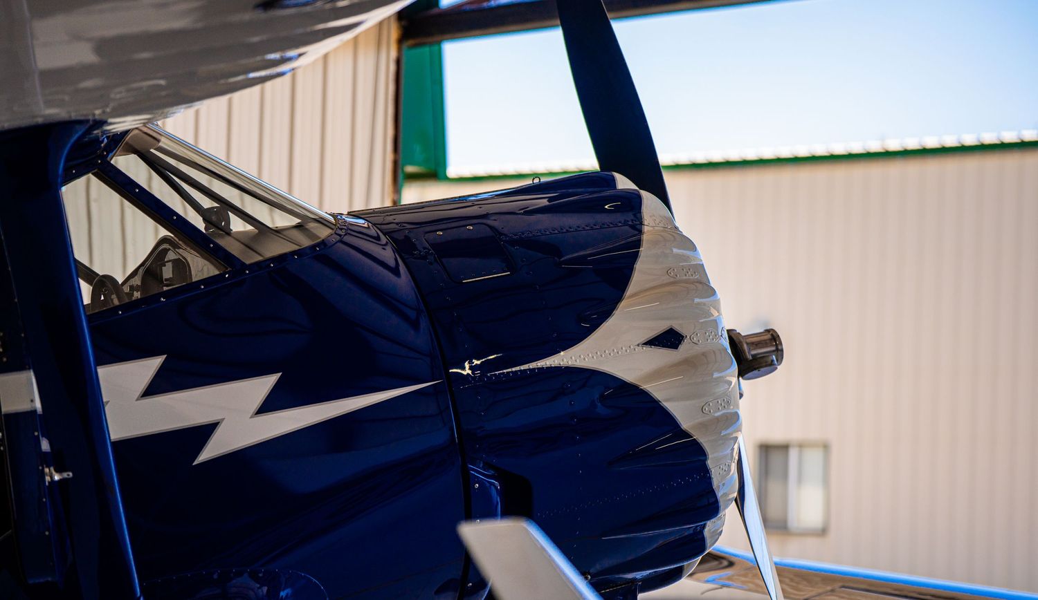 Various angles of a dark blue aircraft's tail section and fuselage.
