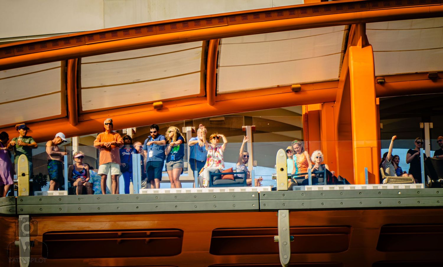 Orange metal beams and support structures line the ceiling of a covered walkway or dock area.