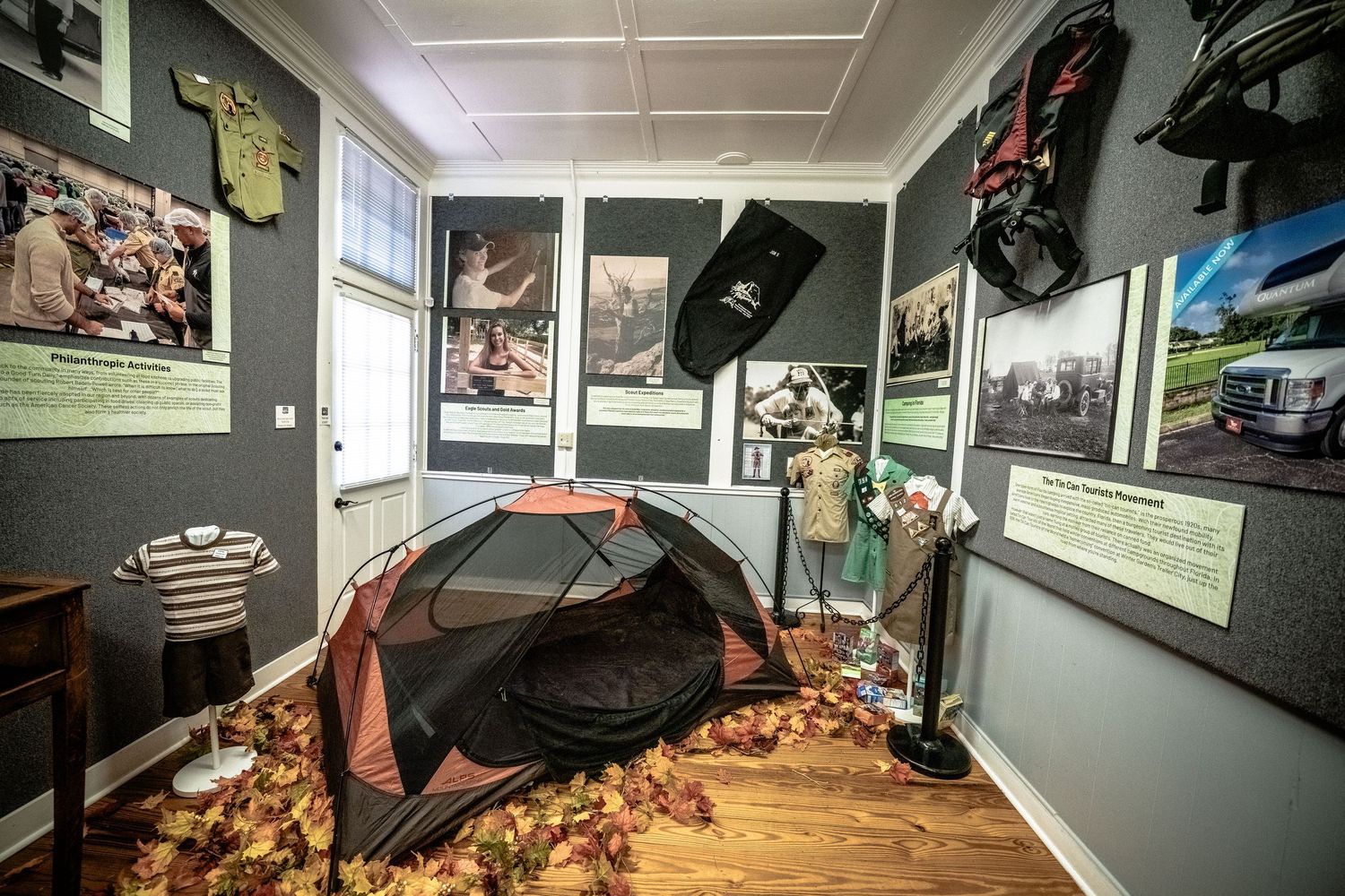 Interior gallery space showing sports memorabilia and historical photographs on walls.