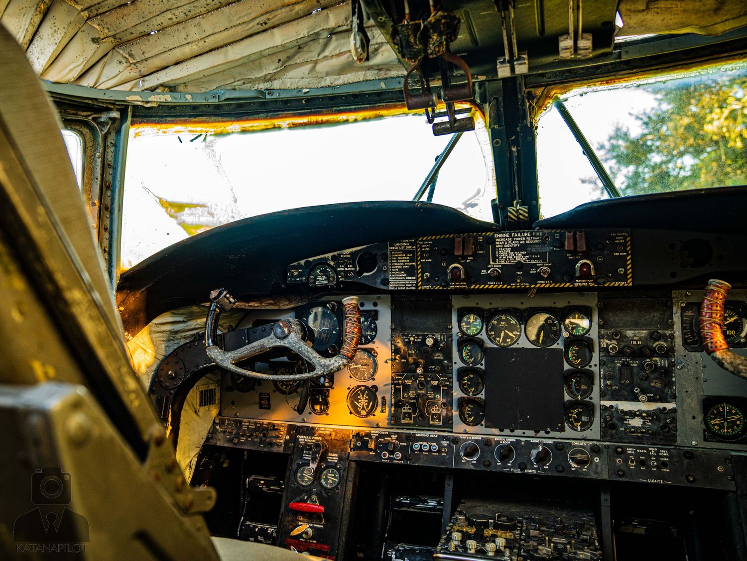 Interior view of old airplane cockpit with worn instrument panels and controls.