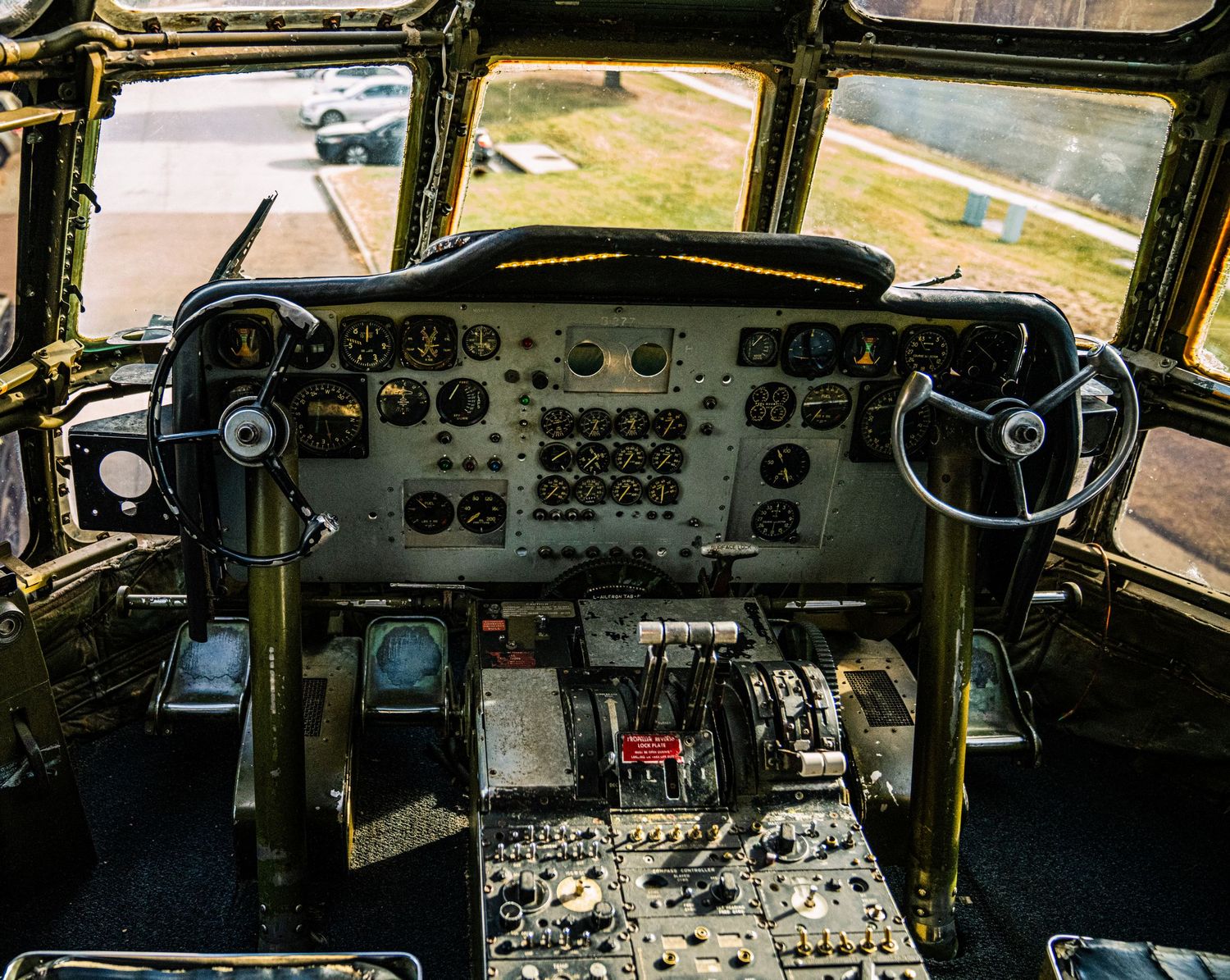 Panoramic view of multiple aircraft cockpit instrument panels showing various gauges, displays and controls.
