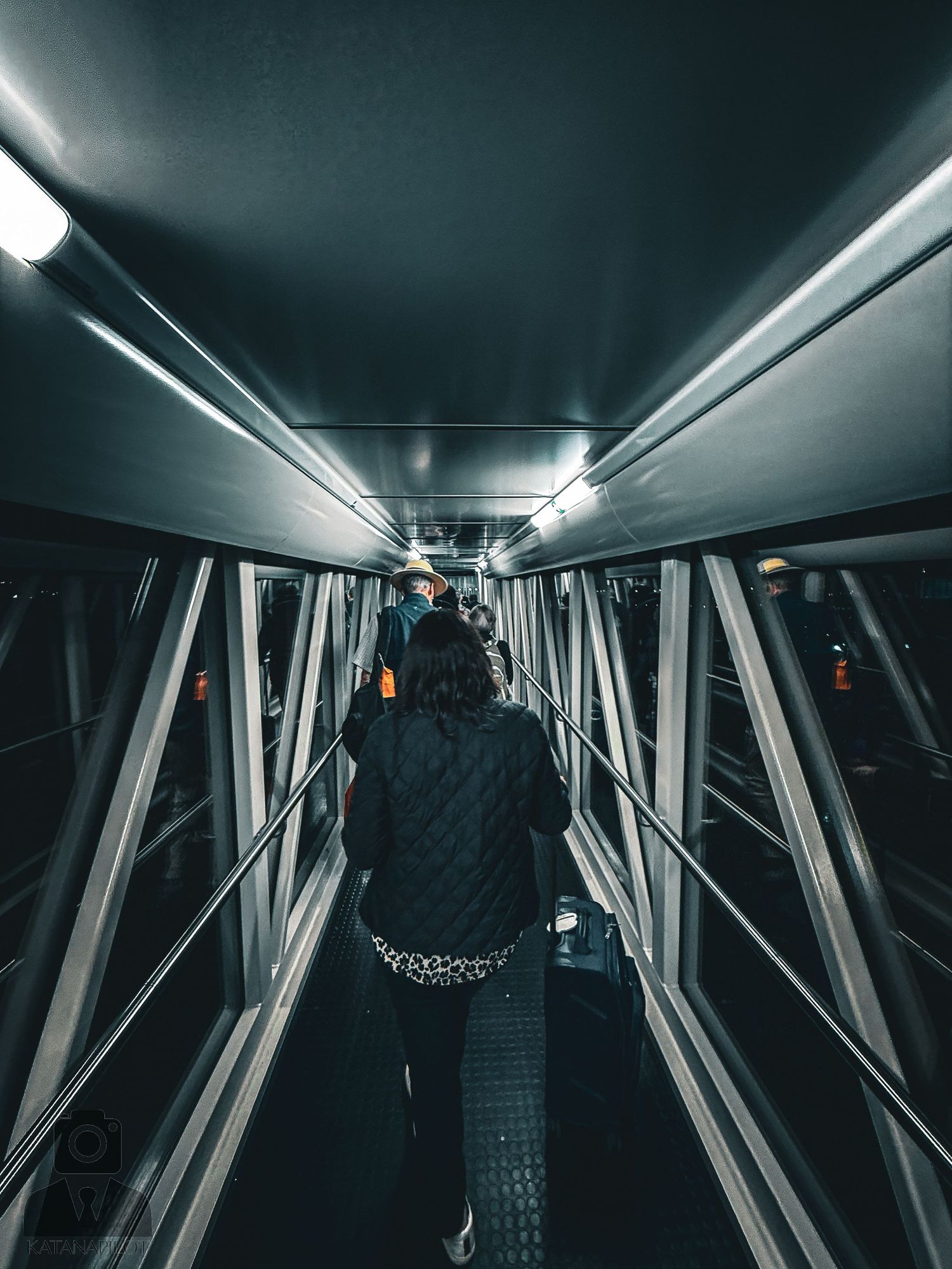 Futuristic tunnel interior with geometric patterns and dramatic lighting.