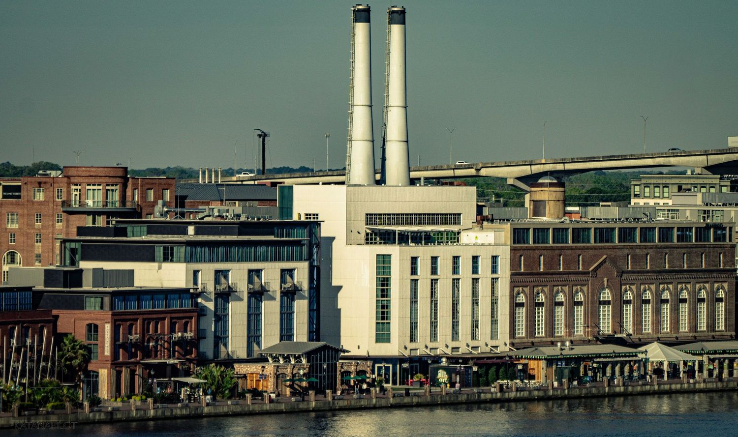 A panoramic cityscape view of Providence, Rhode Island showing industrial buildings and smokestacks along the waterfront.