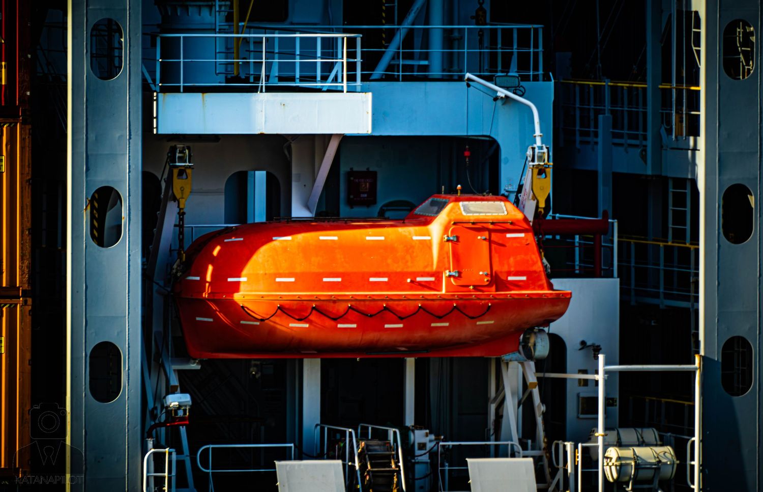 Orange warning lights mounted on industrial equipment in a manufacturing facility.