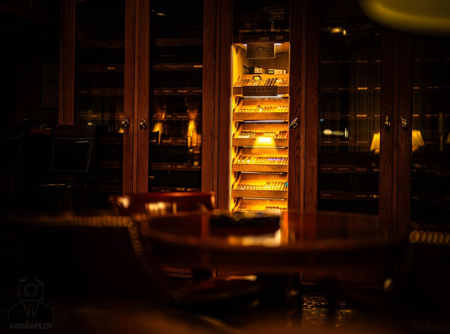 A cozy restaurant interior at night with warm lighting and large windows creating an inviting ambiance.
