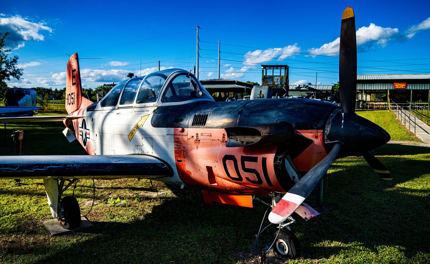 Collection of vintage military aircraft and planes exhibited at an outdoor aviation museum.