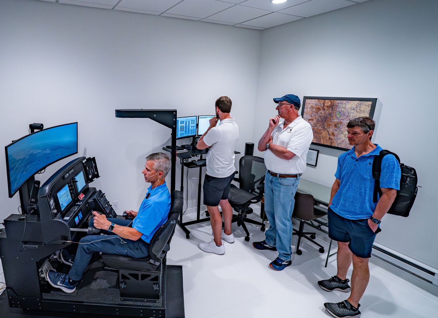 Training room with flight simulation equipment and instructional displays.