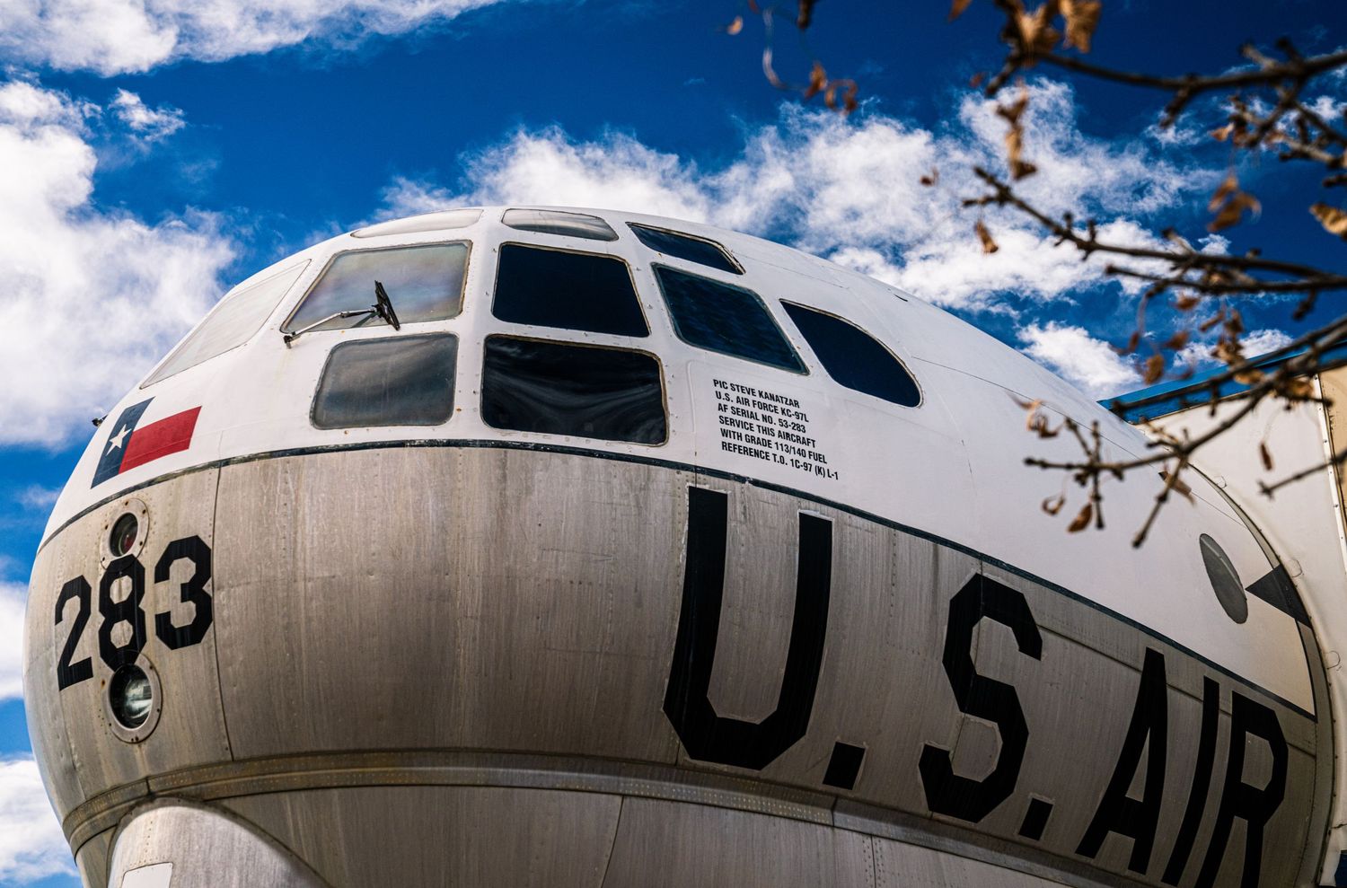 A vintage US Air Force KC-97 Stratotanker aircraft displayed at an outdoor aviation museum against a blue sky.