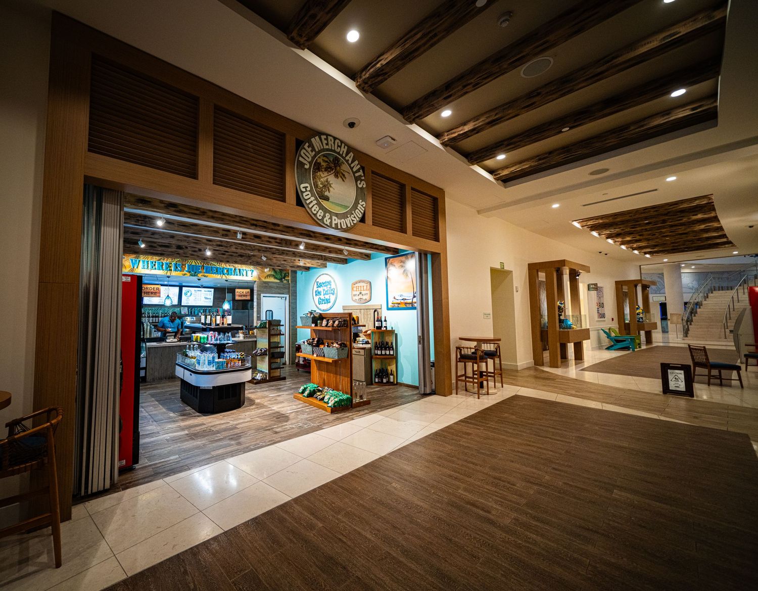 Margaritaville resort interior corridor featuring a cozy cafe shop with warm lighting and polished hardwood floors.