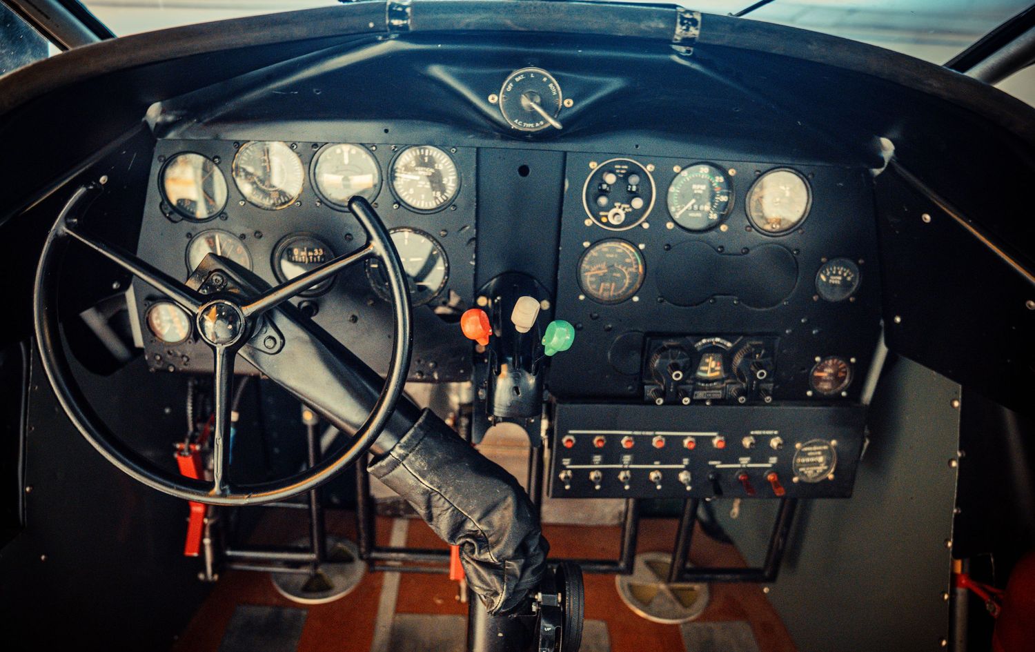 Vintage aircraft control panel dashboard with multiple gauges and instruments.