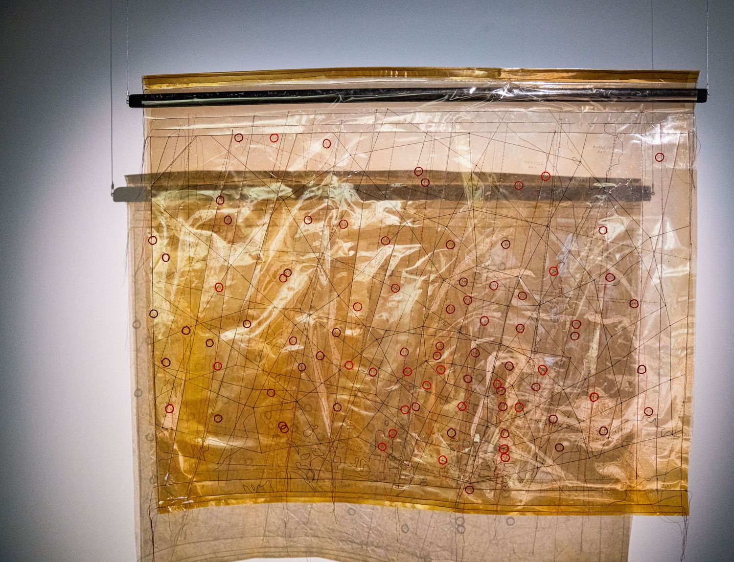 Aged yellow scroll or manuscript displayed in a museum setting.