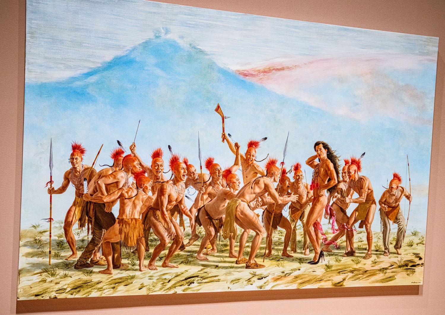 A panoramic mural depicting Native American riders on horseback against a desert landscape with blue sky.