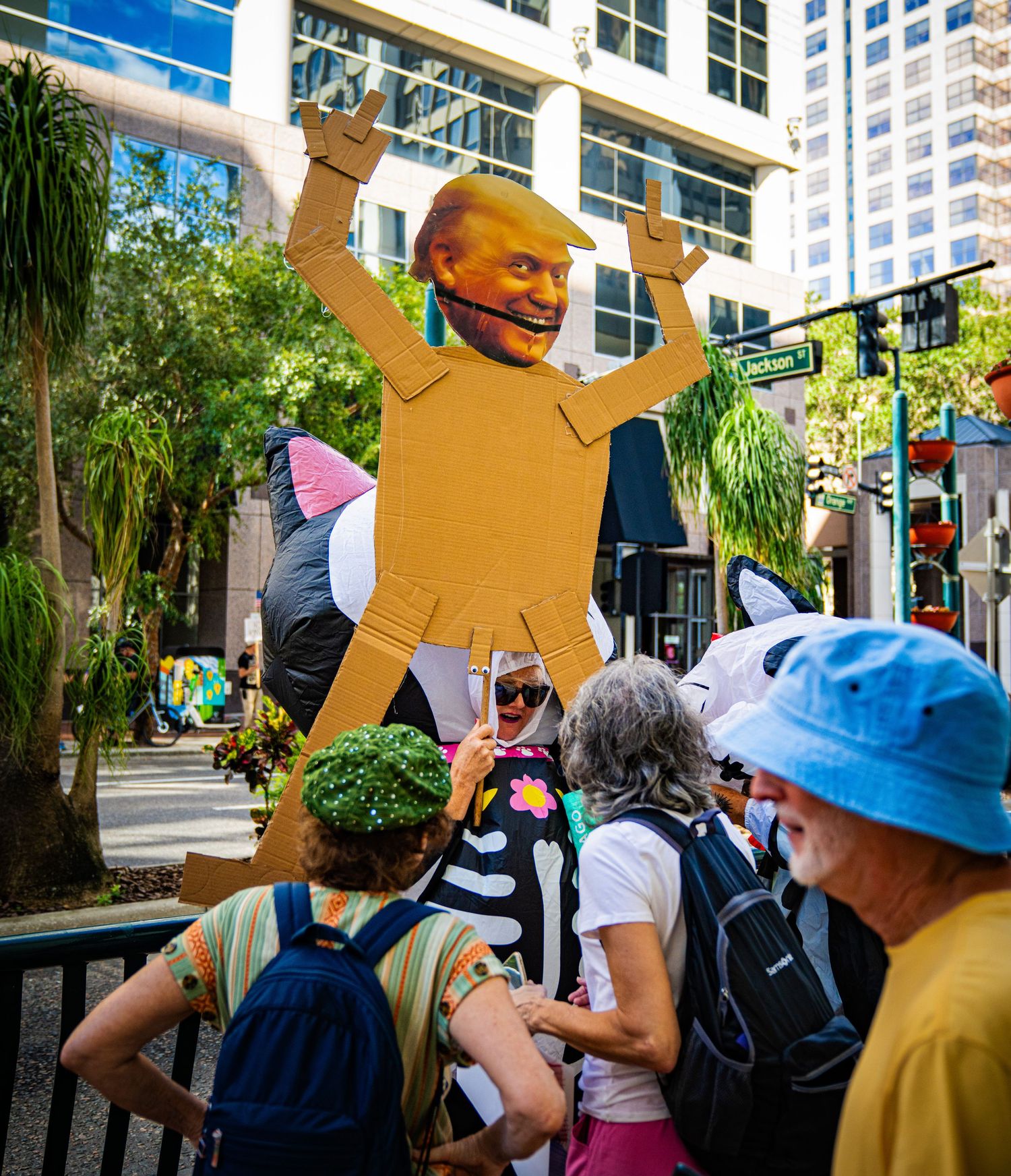 Crowd gathering in downtown Orlando with colorful decorations and banners visible.