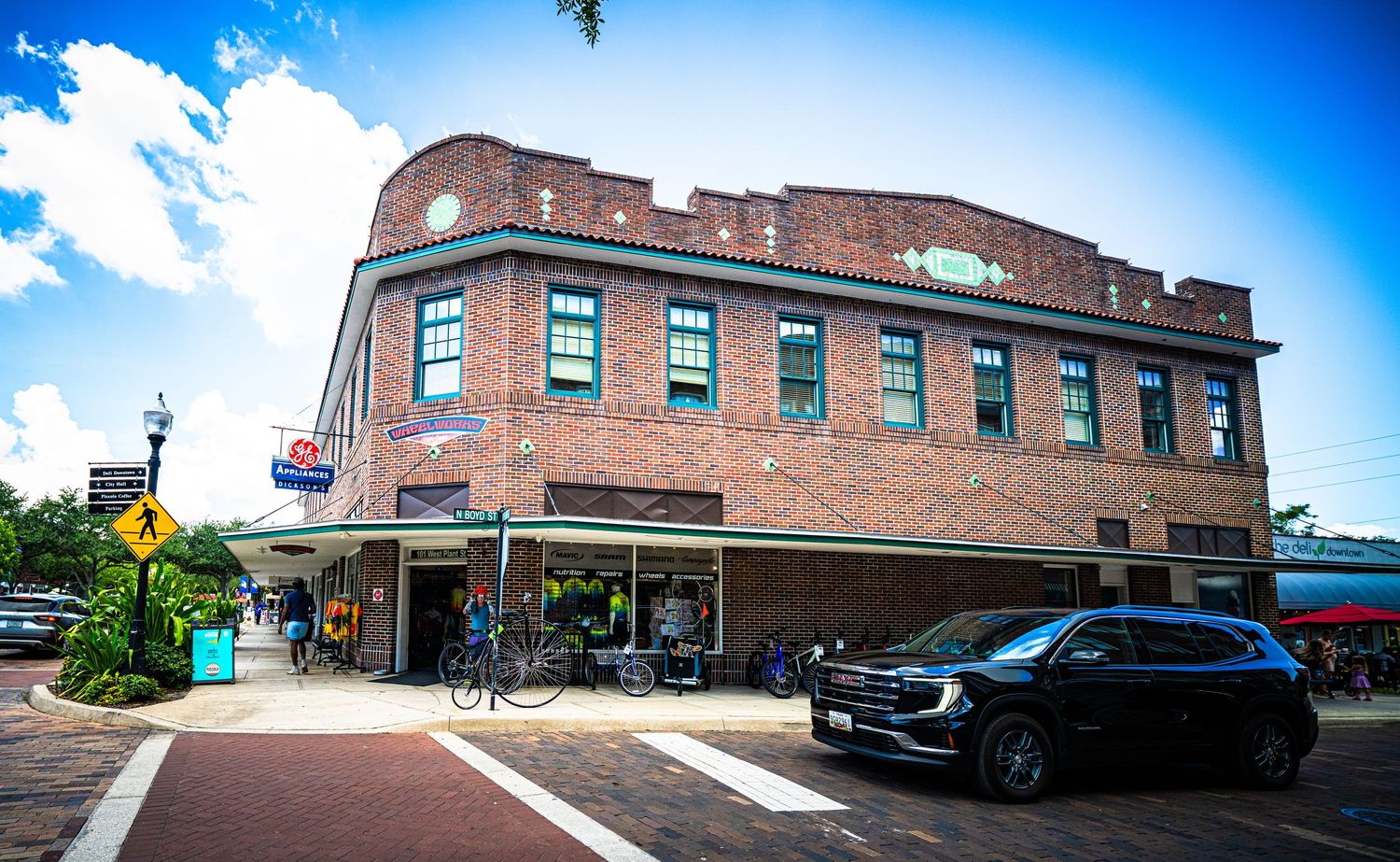 Panoramic view of historic brick buildings along a street with clear blue sky.