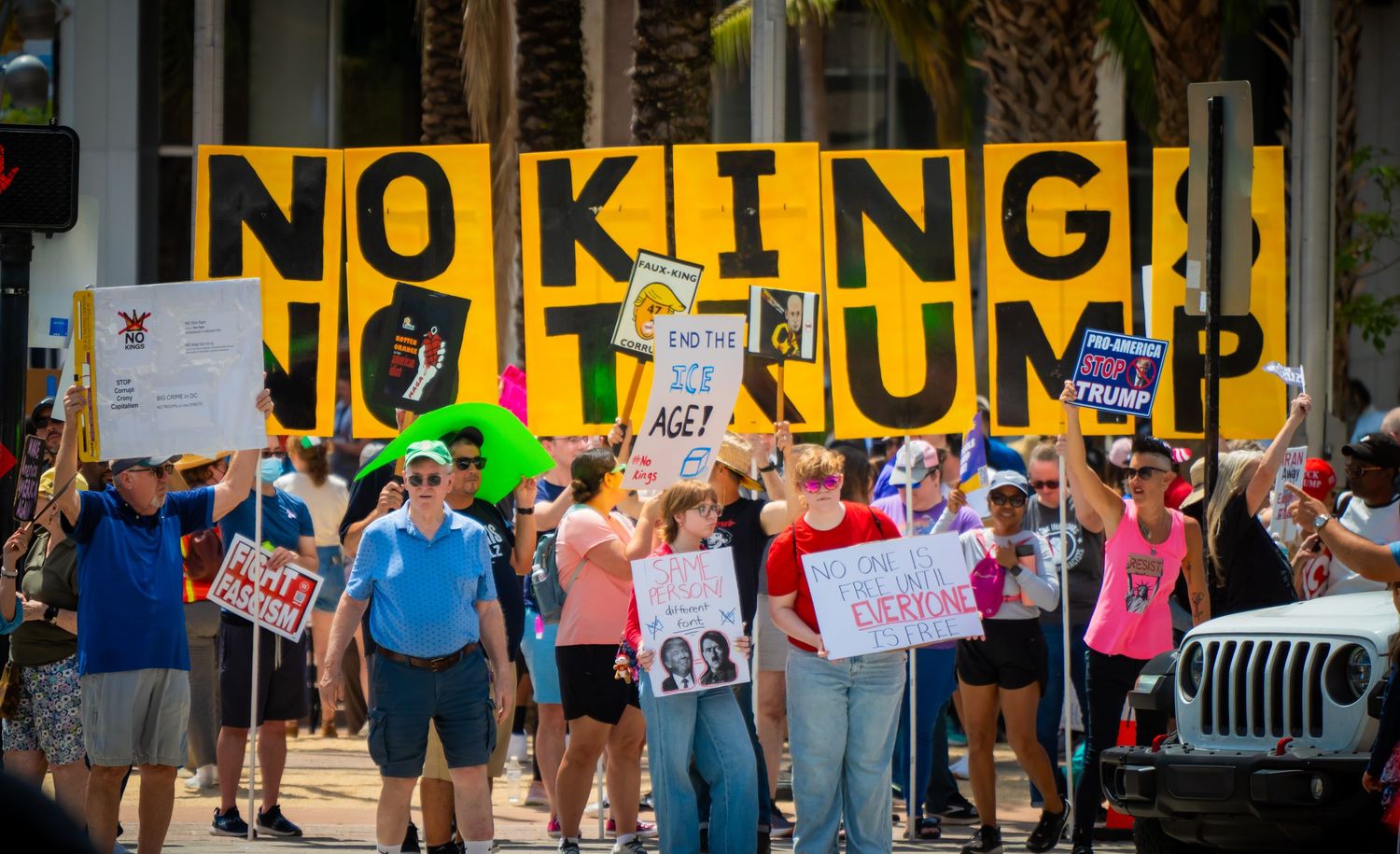 Protesters holding signs and marching in a demonstration against King Charles III's coronation in London.