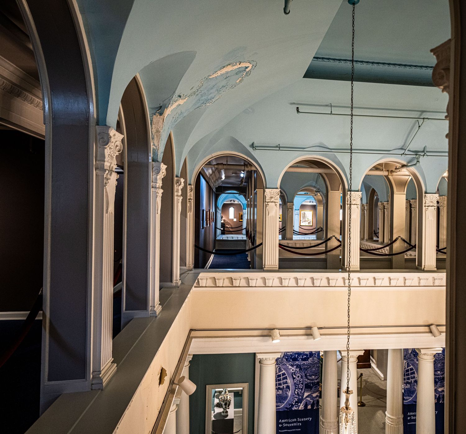 Historic museum gallery space with arched ceilings and classical architectural details.