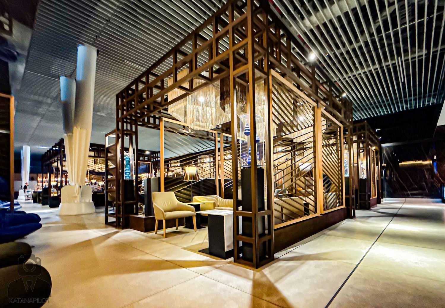 Industrial warehouse space with geometric wooden structures and ambient lighting.