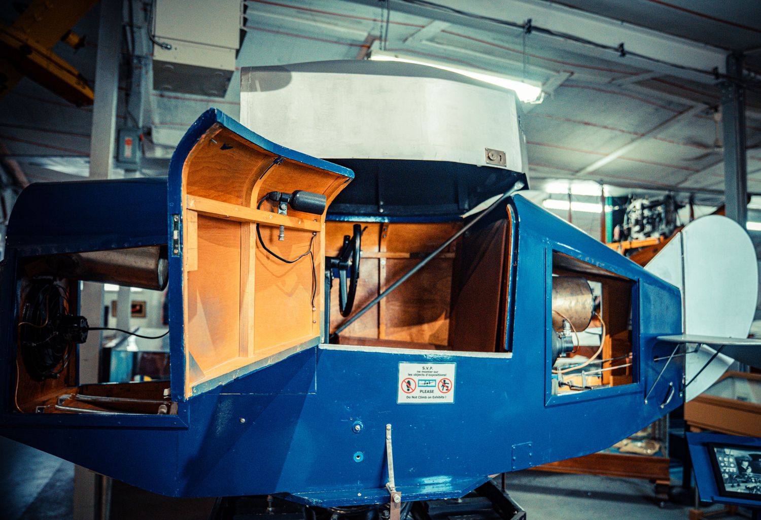Dark indoor space with blue and orange industrial equipment visible.