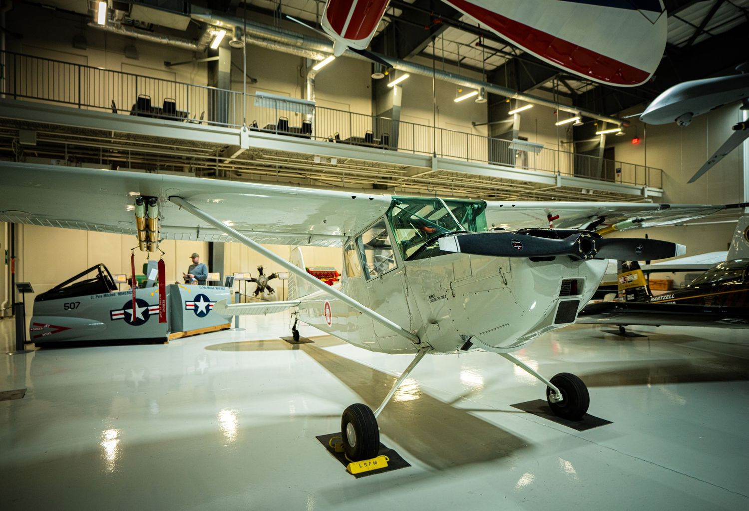 Classic small single-engine Cessna light aircraft preserved and displayed inside an aviation museum hangar.