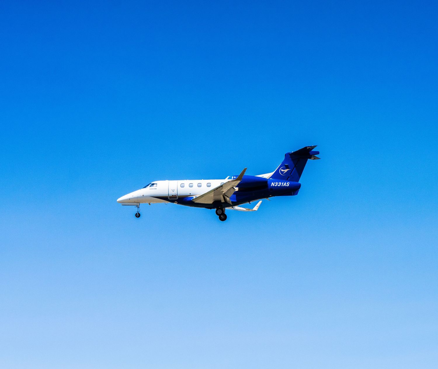 Commercial aircraft flying against bright blue sky in sequence.