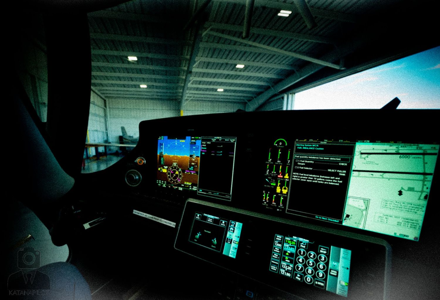 Dark control room with multiple glowing computer displays and monitoring screens.