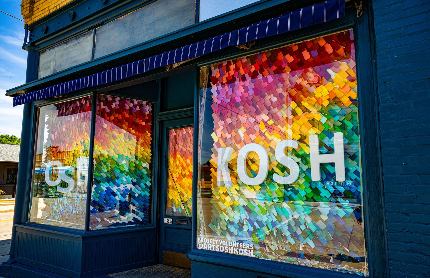 Colorful rainbow window display for POSH store with vibrant prismatic design.