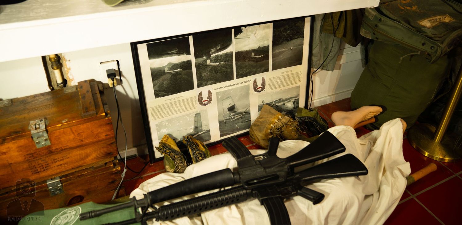 Historic aviation documents and photographs displayed in museum setting.