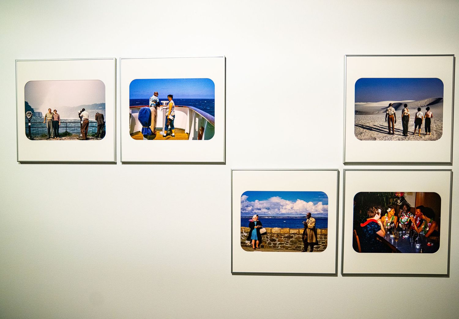 Gallery wall displaying a series of framed photographs in a museum or exhibition space.