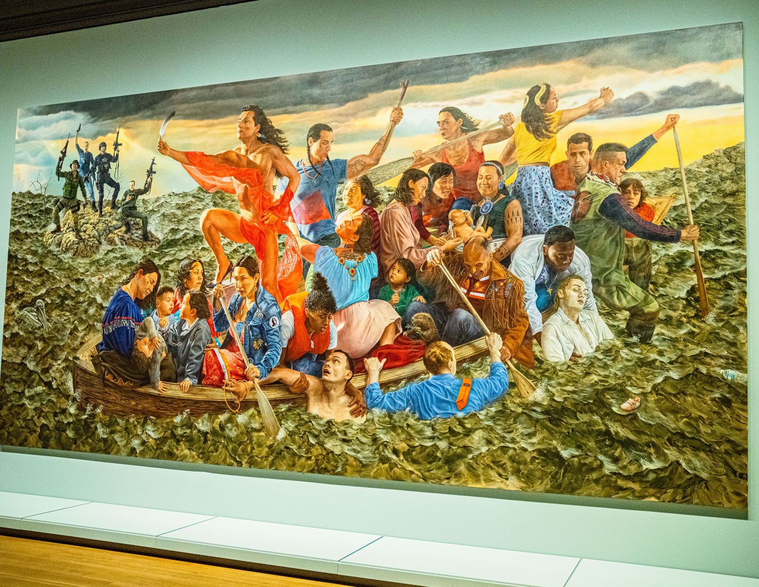 A large colorful mural depicting a dynamic group scene with people in bright clothing gathered on a mountainous landscape.