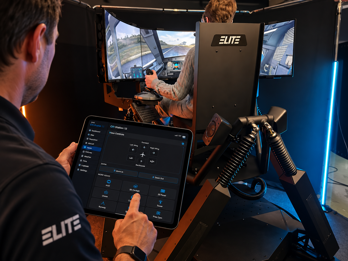 Person using tablet to configure Elite racing simulator setup with triple monitors and steering wheel cockpit.
