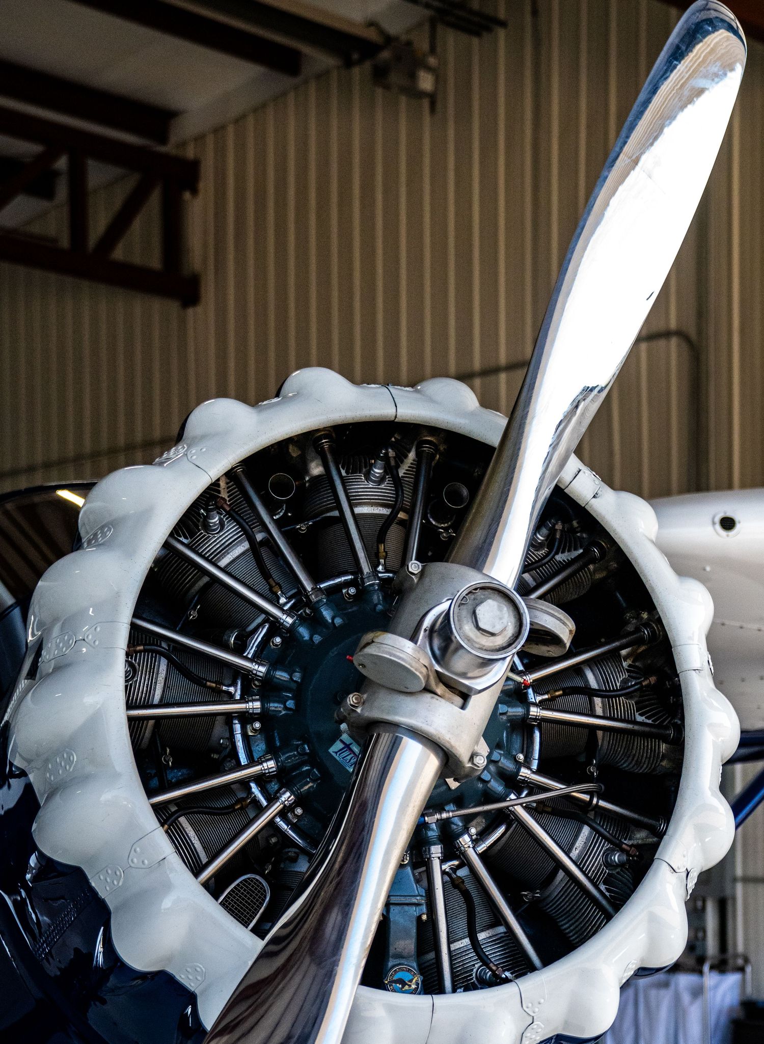Close-up shots of radial aircraft engine with propeller in hangar.