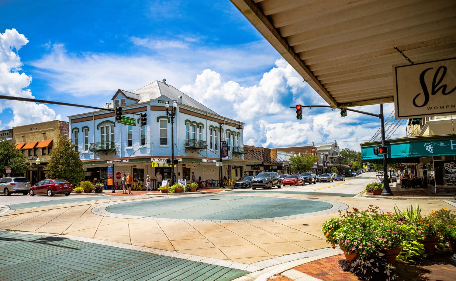 Panoramic streetscape of downtown Sanford showing historic architecture and palm trees.