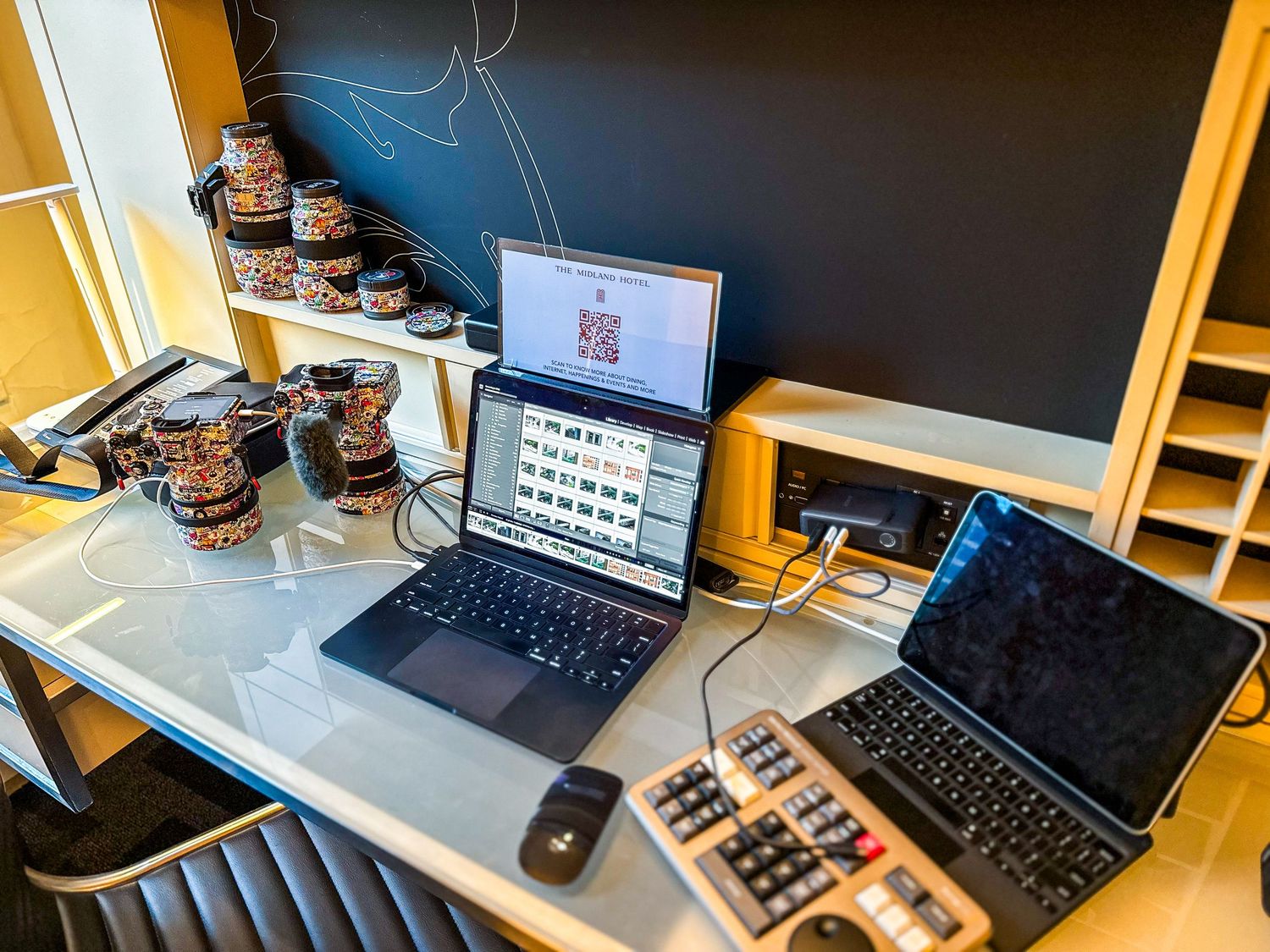 Modern desk setup with multiple keyboards, monitors, and gaming accessories.