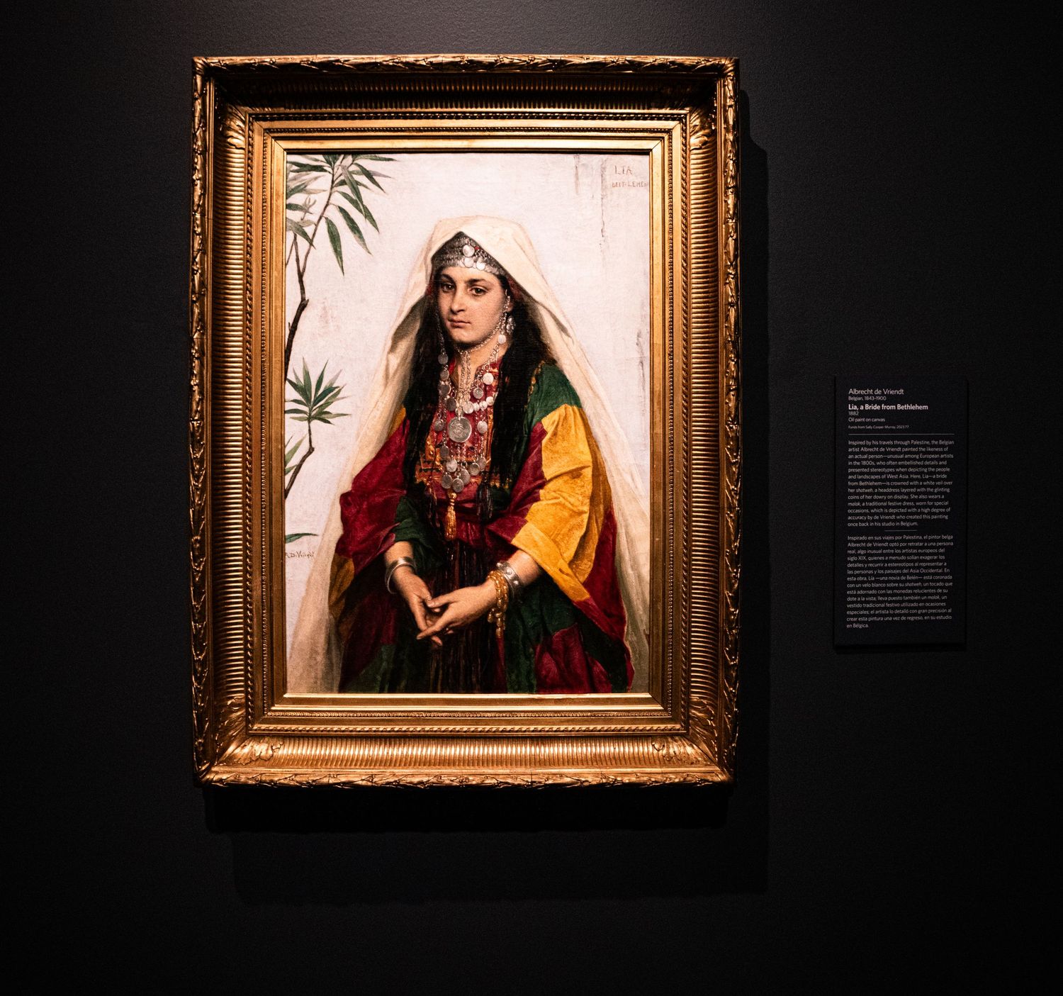 A framed portrait painting in ornate gold frame shows a figure wearing traditional Middle Eastern dress against a light background.